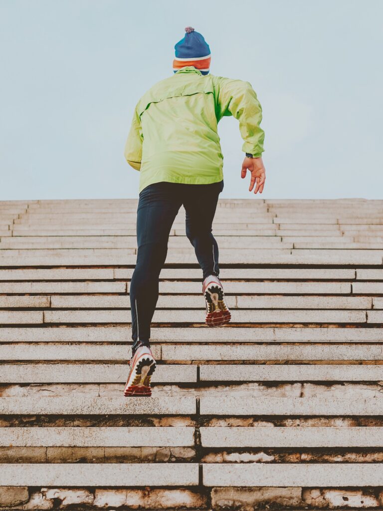 Man running up bleachers