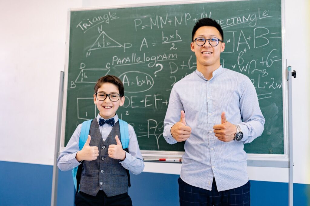 Teacher and student with thumbs up